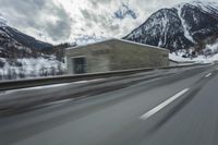 a blurry image of a road in an tunnel with rain, as viewed from the front seat of a car