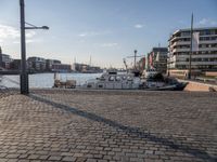 a street view showing the dock and boats in the background with an old fashioned lamp post and tower