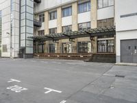 an empty building with signs on the street and people on bikes in traffic passing by