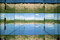 two pictures of a field with a body of water in it and the sky reflected by glass windows