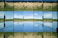 two pictures of a field with a body of water in it and the sky reflected by glass windows