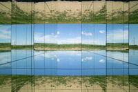 two pictures of a field with a body of water in it and the sky reflected by glass windows