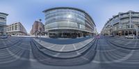 a 360 - vision image of an outside area with cars on the road and in between the buildings