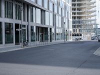 there is a building in the middle of a street with people walking on the street