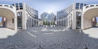 a mirror image shows a curved building with arches in it's interior and arched windows