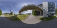 a 360 - image is of a bridge and a building in front of it with trees