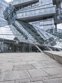 empty walkway with the stairs up to the roof and glass building in background, outdoors