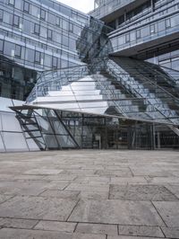 empty walkway with the stairs up to the roof and glass building in background, outdoors
