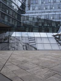 empty walkway with the stairs up to the roof and glass building in background, outdoors