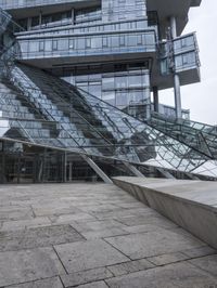 empty walkway with the stairs up to the roof and glass building in background, outdoors