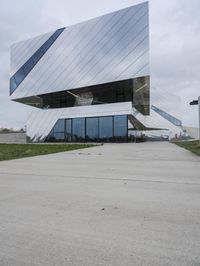 a person is walking on the pavement near the building while wearing a backpack in the air