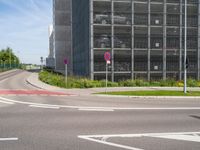 there are three signs next to a road that is wide enough for traffic to cross