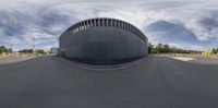 a fish eye lens view of a construction site with a building in the background,