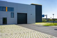 a grey garage that is located on the side of the street with yellow shutters