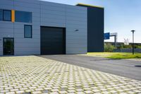 a grey garage that is located on the side of the street with yellow shutters