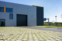 a grey garage that is located on the side of the street with yellow shutters