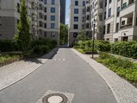 a brick road with white steppings leading to white apartment buildings that appear similar, but different styles of apartments