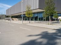 the shadow of a bicycle on the sidewalk of a building that is standing next to the road