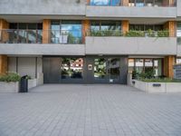 a large courtyard with a fire hydrant near some buildings and windows that look like glass