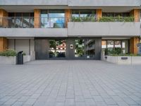 a large courtyard with a fire hydrant near some buildings and windows that look like glass