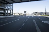 a blurry image of a street and a car with its headlights on it,