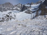 a very big mountain with some snow and a person wearing skis on it during the day