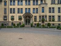 large yellow building with some plants and bushes in front of it for decoration or entertainment