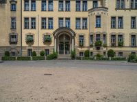 large yellow building with some plants and bushes in front of it for decoration or entertainment