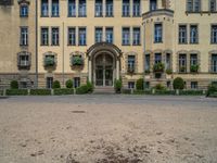 large yellow building with some plants and bushes in front of it for decoration or entertainment