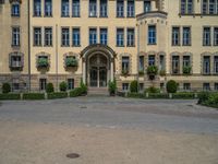 large yellow building with some plants and bushes in front of it for decoration or entertainment