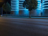 this is an image of a city street at night time with blue light shining brightly