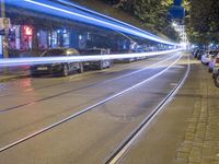 long exposure of the city at night, showing street lights in motion, and people on bicycles passing