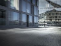 an blurry image of a man walking down a street carrying his bike in hand