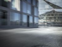 an blurry image of a man walking down a street carrying his bike in hand