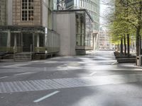 an empty city street in front of modern buildings in the city of london, uk