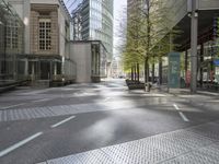 an empty city street in front of modern buildings in the city of london, uk