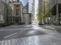 an empty city street in front of modern buildings in the city of london, uk