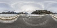 a panoramic lens is pictured to show the camera, the road and mountains