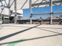 the large parking lot in front of a stadium has many stairs and green numbers on it