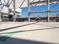 the large parking lot in front of a stadium has many stairs and green numbers on it