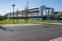 an empty street and an office building in the distance on a clear day in europe