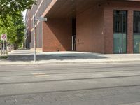 a red car sitting in front of a building with a traffic signal on the street