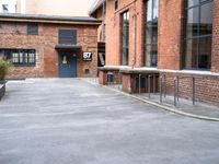 a bike parking space near some red brick buildings and stairs with benches on both sides of the walkway