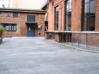 a bike parking space near some red brick buildings and stairs with benches on both sides of the walkway