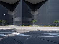 a black building with black squares on the top and bottom, along with a stop light and no parking