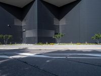 a black building with black squares on the top and bottom, along with a stop light and no parking