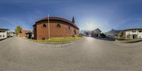 a panorama photograph of a large building with a clock tower at the top of it