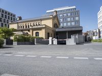 a large building with a parking lot in front of it and some buildings behind it