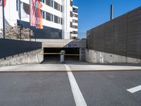 a parking garage with a concrete wall and street scene in the background for an article on how to avoid car bumps