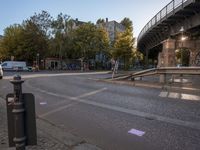 a crosswalk going under a bridge over a road with graffiti on the ground and signs painted on it